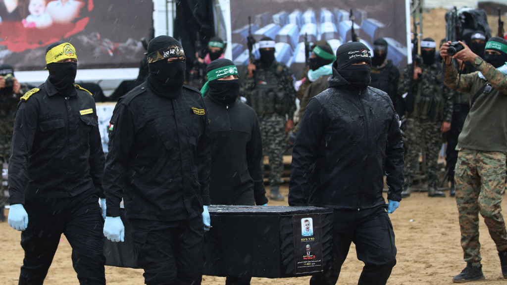 Hamas members carry a coffin to the stage_Photo Credit_Getty Images