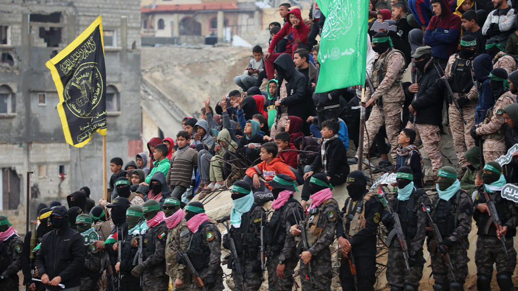 Palestinians and Hamas members gather to watch the transfer of the bodies of four Israeli hostageson Feb. 20 2025 (EYAD BABA_AFP via Getty Images)